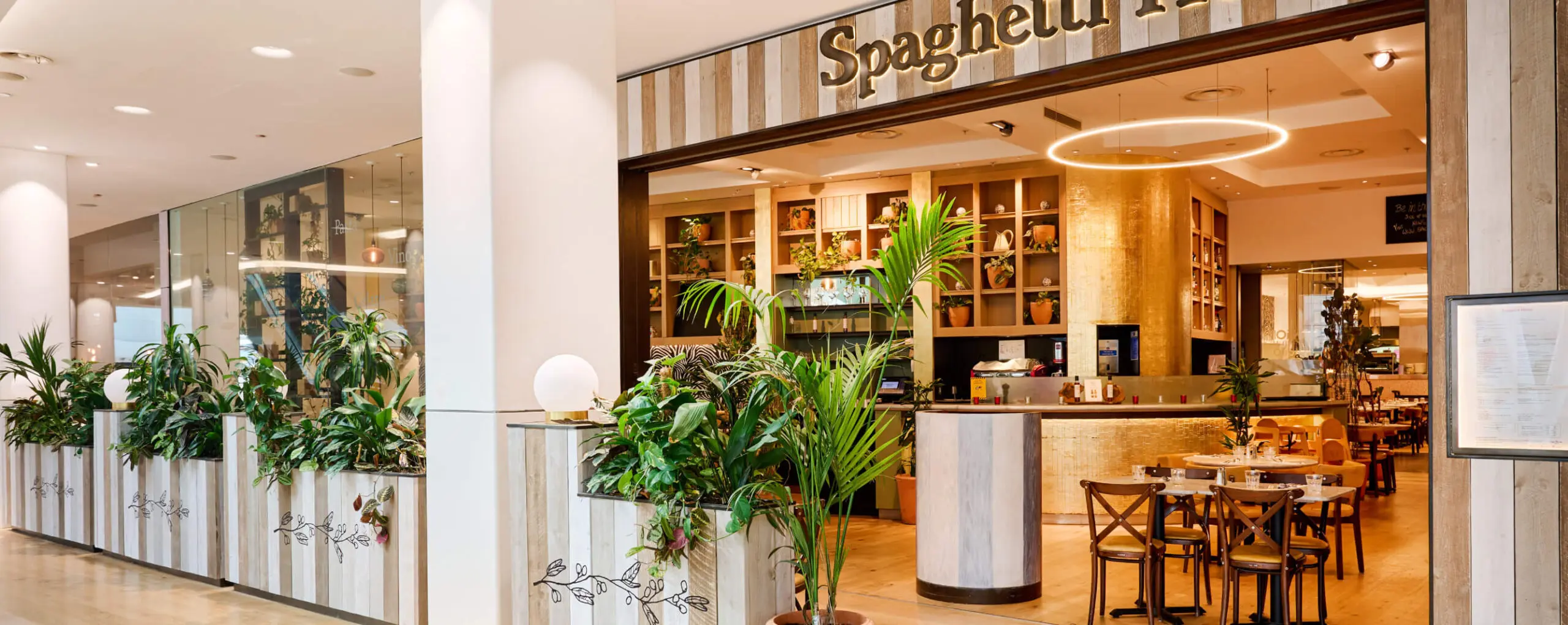 A cozy Italian restaurant nestled in Westfield White City, with wooden decor and a sign reading 